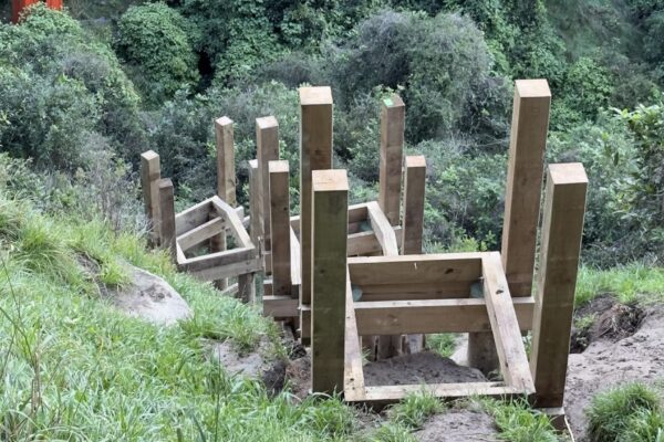 Timber staircase under construction on a steep hillside at Barnett Park, forming part of a walking track construction and recreation construction upgrade. This image shows civil contractors delivering timber structures, park construction, siteworks and erosion control in a natural reserve.