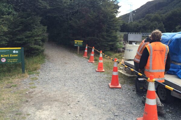 Site preparation for bridge repair and bridge maintenance works, with safety cones and equipment set up at the access track near the riverbed. This image shows civil contractors managing project access, siteworks, bridge inspection services and civil construction in a remote bridge location.