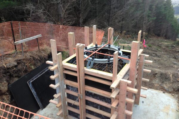 Timber formwork and reinforcing prepared for a concrete structure foundation in a forested civil construction site. This image highlights civil contractors completing foundation construction, site preparation and structure construction for adventure infrastructure and park construction.