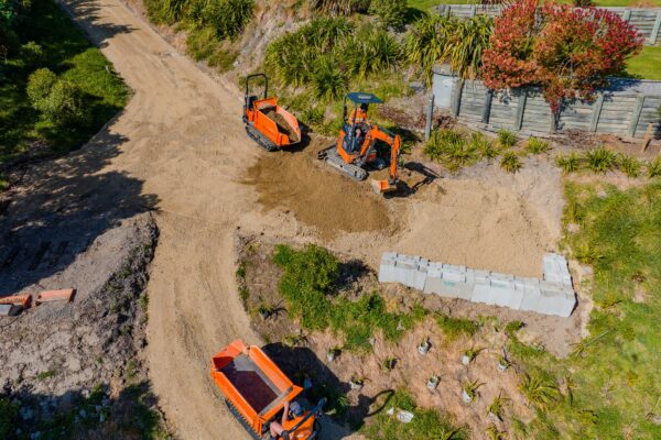 Aerial view of walking track construction in a forest reserve, with compact machinery shaping paths and drainage features. The project shows recreation construction, civil construction, erosion control and siteworks for public access infrastructure.