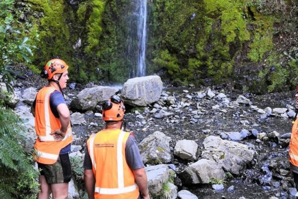 Civil contractors inspecting the waterfall area during Hanmer walking track construction and recreation construction works. This image highlights park construction, siteworks, erosion control and project management in a rocky stream environment.