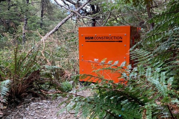 HGM Construction sign beside a forest walking track during recreation construction and park construction works. The image highlights civil contractors, walking track construction, site preparation, siteworks and project management in a native bush environment.