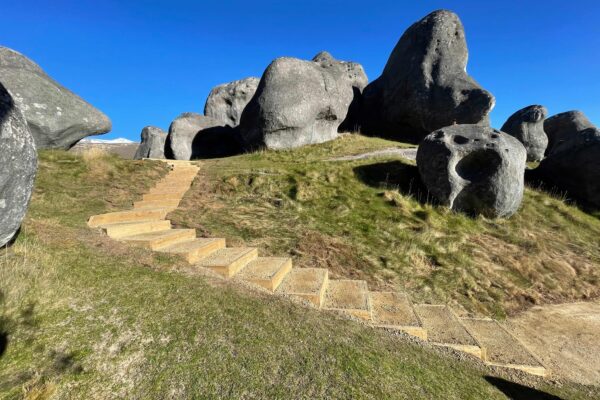 Completed walking track and timber steps winding through limestone boulders at Kura Tawhiti Castle Hill, improving access through the recreation area. The image highlights civil construction, park construction, erosion control and project management in a sensitive landscape.