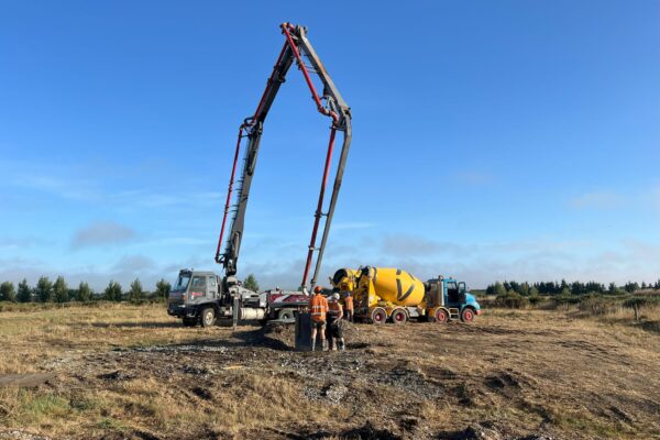 Concrete pumping and foundation construction underway for power infrastructure, with civil contractors preparing a pole base in open rural land. This image highlights civil construction, concrete structure works, bored piles, utility infrastructure and project management.