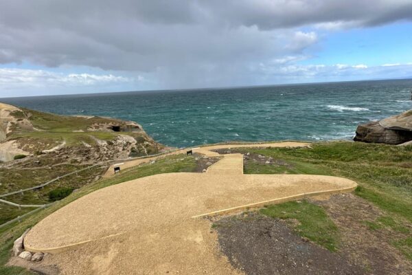 Coastal walking track construction with a finished gravel path and viewing area above the shoreline. The image shows recreation construction, erosion control, siteworks and civil construction designed to improve safe access through a coastal landscape.