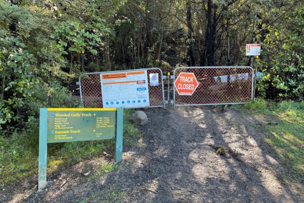 Track closed signage at the entrance to a wooded recreation construction site, where civil contractors are completing walking track construction and park construction works. The image reflects project management, site preparation and civil construction planning for a public track upgrade.